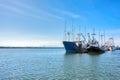 Small fishing trawler and tugboat moored at the ocean pier Royalty Free Stock Photo