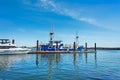 Small fishing trawler and whte yacht moored at the ocean pier Royalty Free Stock Photo