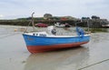 Small fishing vessel at low tide Royalty Free Stock Photo