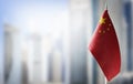 A small flag of China on the background of a blurred background Royalty Free Stock Photo