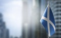 A small flag of Scotland on the background of a blurred background Royalty Free Stock Photo