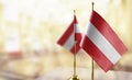 Small flags of the Austria on an abstract blurry background