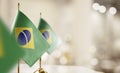 Small flags of the Brazil on an abstract blurry background Royalty Free Stock Photo