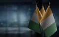 Small flags of the Cote dIvoire on an abstract blurry background