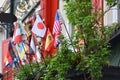 Small flags of different countries on the balcony of one of the houses in Europe. Flags of different countries, America, Japan,