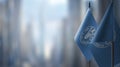 Small flags of the Food and agriculture organization on an abstract blurry background