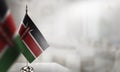 Small flags of the Kenya on an abstract blurry background