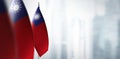 Small flags of Taiwan on a blurry background of the city Royalty Free Stock Photo