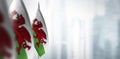 Small flags of Wales on a blurry background of the city Royalty Free Stock Photo