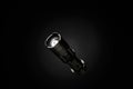 Small flashlight isolated on black background with soft reflection and copy space Royalty Free Stock Photo