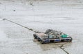 Small flat barge loaded with fishing supplies