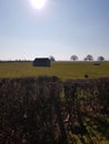 Small flint knapp barn in a Sussex field. Royalty Free Stock Photo