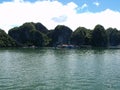 Small floating fishing village among large rock mountains in Ha Long Bay. Vietnam Royalty Free Stock Photo