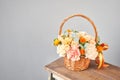 Small flower shop and Flowers delivery. Flower arrangement in Wicker basket. Beautiful bouquet of mixed flowers in woman