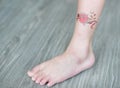 Small flower tattoo sticker on child ankle, Dress up tattoo