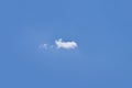 Small, fluffy and lonely clouds in the blue sky. Royalty Free Stock Photo