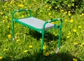 small folding garden bench for weeding. green water.