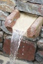 The small fontain with flowing water Royalty Free Stock Photo