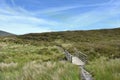 Small footbridge on hillside path Royalty Free Stock Photo