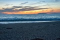 Small footprints on the sand of Milazzo beach during the sunset and the Aeolian Islands in the background Royalty Free Stock Photo