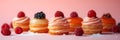 small French desserts, mini cakes, on a peach-colored background