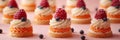 small French desserts, mini cakes, on a peach-colored background