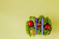 Small Fresh vegetables in basket on yellow background. Food background concept with copyspace Royalty Free Stock Photo