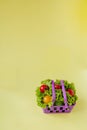 Small Fresh vegetables in basket on yellow background. Food background concept with copyspace Royalty Free Stock Photo