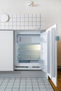 Small fridge built in cupboard in kitchen Royalty Free Stock Photo