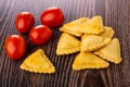 Fried savory pies, red tomatoes on table