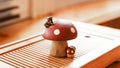 A small frog sitting on a fly agaric. Clay tea figurine, teapet, attribute of the Chinese tea ceremony Royalty Free Stock Photo