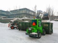 Small front-end loaders clear snow from the street and load into a bunker