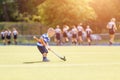 Small funny boy playing field hockey