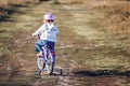 Small funny kid riding bike