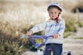 Small funny kid riding bike