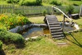 Small garden pond with wooden bridge Royalty Free Stock Photo