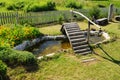 Small garden pond with wooden bridge Royalty Free Stock Photo