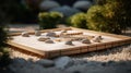 a small garden with rocks and a bamboo board in the middle of the ground and a few trees in the back ground and rocks in the