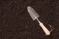 Small garden trowel lying on rich brown earth