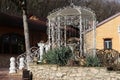 A small gazebo with carved walls and a sculpture of a couple under an umbrella. A cozy place for a pleasant stay