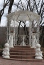 A small gazebo with carved walls and a sculpture of a couple under an umbrella. A cozy place for a pleasant stay