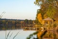 A small gazebo and a pier near the lake for fishing.