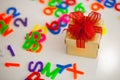Small gift box and colorful abc alphabet block plastic letters,