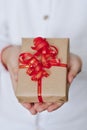 Small gift in the hands of little girl present for Christmas, Valentine Day, New Year, birthday. Top view Royalty Free Stock Photo