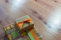 Small gift stacked on a larger gift, diagonal, orange ribbon on brown and vintage wrapping papers, retro