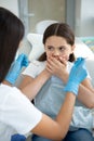 Small girl is afraid of dentist in modern dental clinic