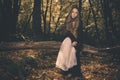 Small girl alone in wild forest in style of halloweeen witch Royalty Free Stock Photo