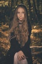 Small girl alone in wild forest in style of halloweeen witch Royalty Free Stock Photo