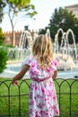 Small girl in beautiful dress admiring fountain in Verona Italy Royalty Free Stock Photo