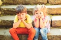 Small girl and boy on stairs. Relations. summer vacation. childhood first love. couple of little children. sad boy and Royalty Free Stock Photo